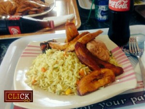 Plate of fried rice, meat and plantain, served with coke in an Enugu restaurant