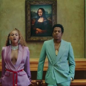 Beyonce in pink suit, JayZ in green suit
