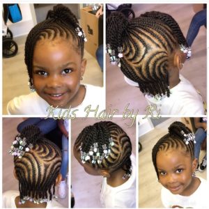 Little black girl with natural hair braided into cornrows, decorated with beads