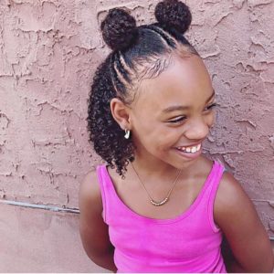 Little girl with her natural hair styled half up half down, with two buns on top