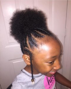 Pretty little girl with cornrows leading to an afro puff