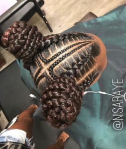 Girl with beautiful stitch braids ending in braided buns