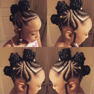 Little girl with creative cornrow braids forming three braided buns
