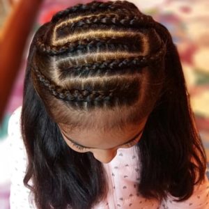 Little girls with five alternating braid on top of her head, ending in pigtails