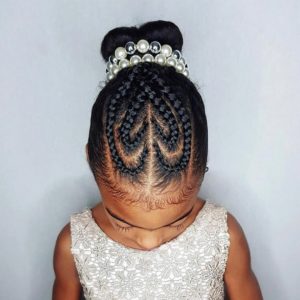 Little girl with her natural hair styled into a heart-shaped updo, with cornrow braids in front forming two heart shapes
