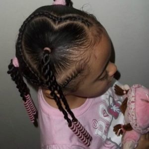 Little black girl with creative heart-shaped part twisted into a braid