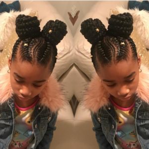 Little black girl with beautiful stitch braids ending in braided space buns