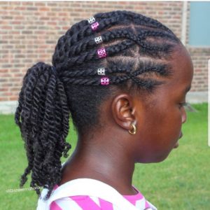 Little black girl with natural hair cornrowed in front and twisted ponytail at the back