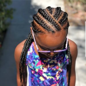 Little black girl with seven stitch braids