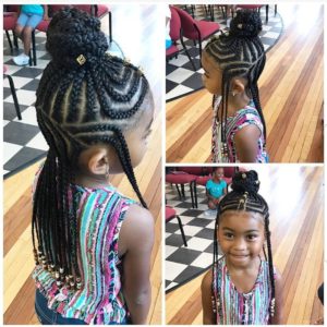 Pretty little girl with Fulani braids made in the half up half down style