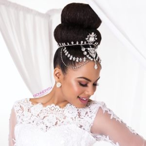 elegant double bun bridal hairstyle with jeweled wedding hair accessory