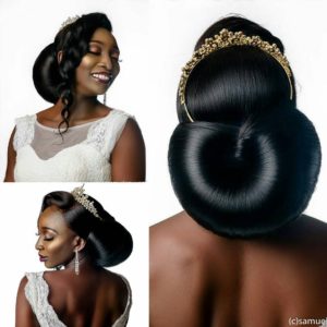 beautiful bride wearing sleek low bun with tiara and bridal jewelr