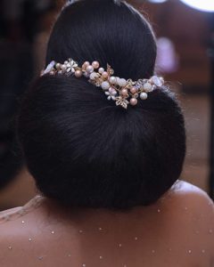 simple low bun with wedding hair accessory