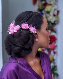 creative low bun wedding hairstyle with flower wedding hair accessories
