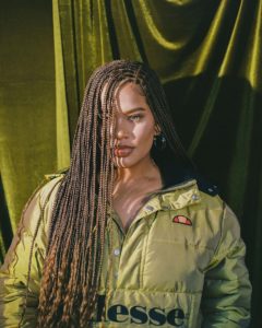 black woman in two-toned box braids hairstyle with curly ends