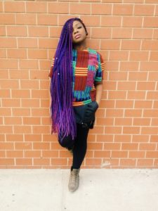 black girl wearing very long purple box braids hairstyle