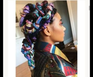 Black girl wearing box braids hairstyle with mutliple colors