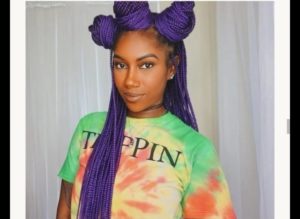 black girl wearing blue box braids hairstyle twisted intp thre jumbo buns in front