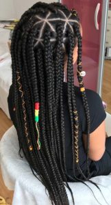 black girl wearing box braids with triangle parting and accessories