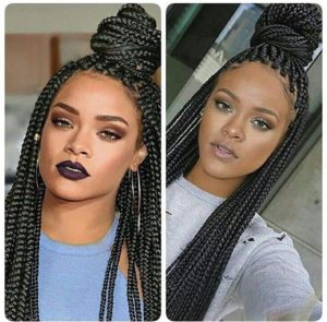 Rihanna wearing black box braids hairsstyle with a bun on top