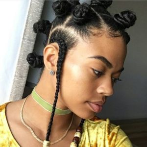black girl wearing bantu knots and cornrows