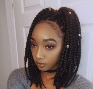 black girl with box braids pulled up into pigtails
