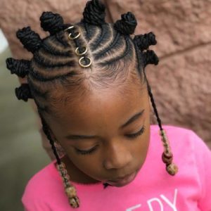 Little black girl with creative Bantu knots style with braids and accessories.