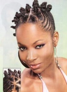 black woman with cornrows and the side and bantu knots on top