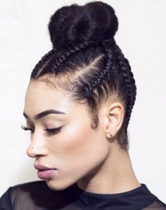 lady with bold cornrows twisted into an updo knot