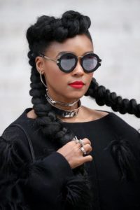 Janelle Monae in black with braided pigtails