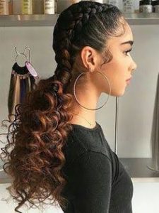 woman wearing pigtail braids with curly ends