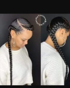 black woman wearing two feed-in ffrench braids that merge into one