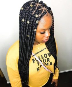 black girl wearing dark long braids on triangle roots.