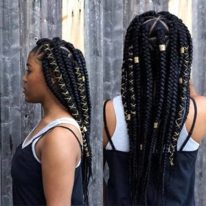 black girl wearing jumbo triangle braids accessorized with cords and cuffs.