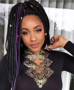 pretty black girl wearing black box braids with purple highlights and gold accessories