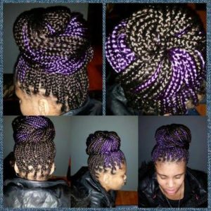 black woman with black and purple box braids swept up in a huge bun