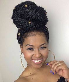 black woman with small box braids packed up in a jumbo bun