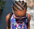 Little black girl with seven stitch braids